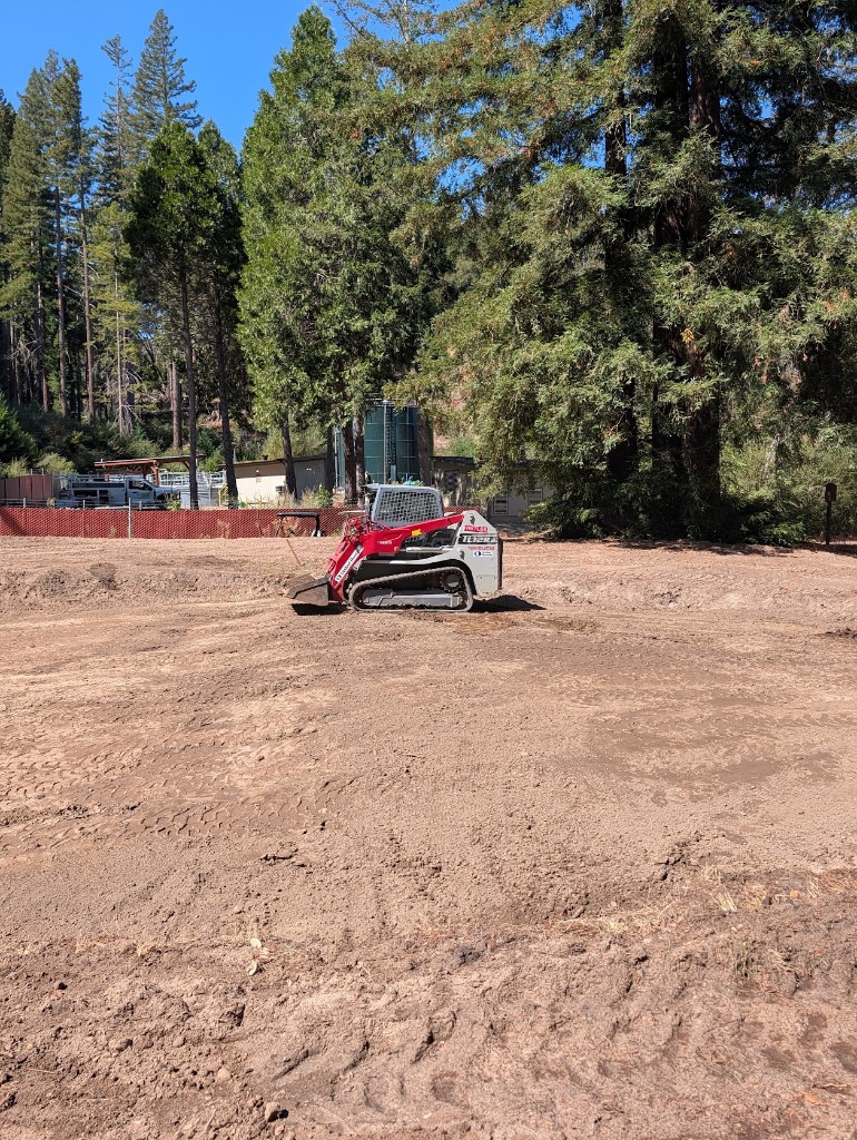 Track loader parked on graded dirt during back nine reconstruction